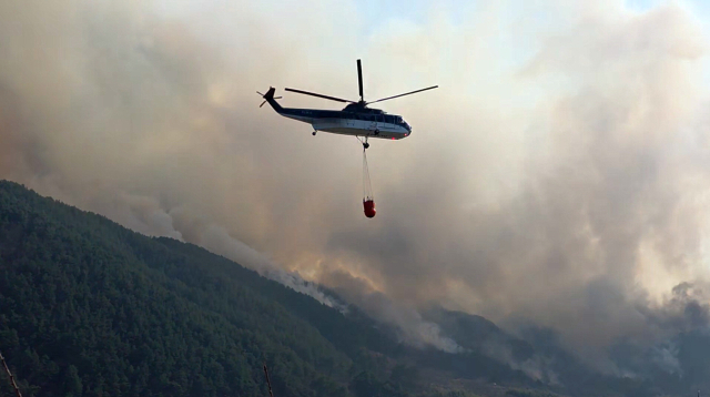 3월 22일 경남 산청군 시천면에서 산불진화헬기가 방화수를 채우고 산불 현장으로 이동하고 있다. 연합뉴스